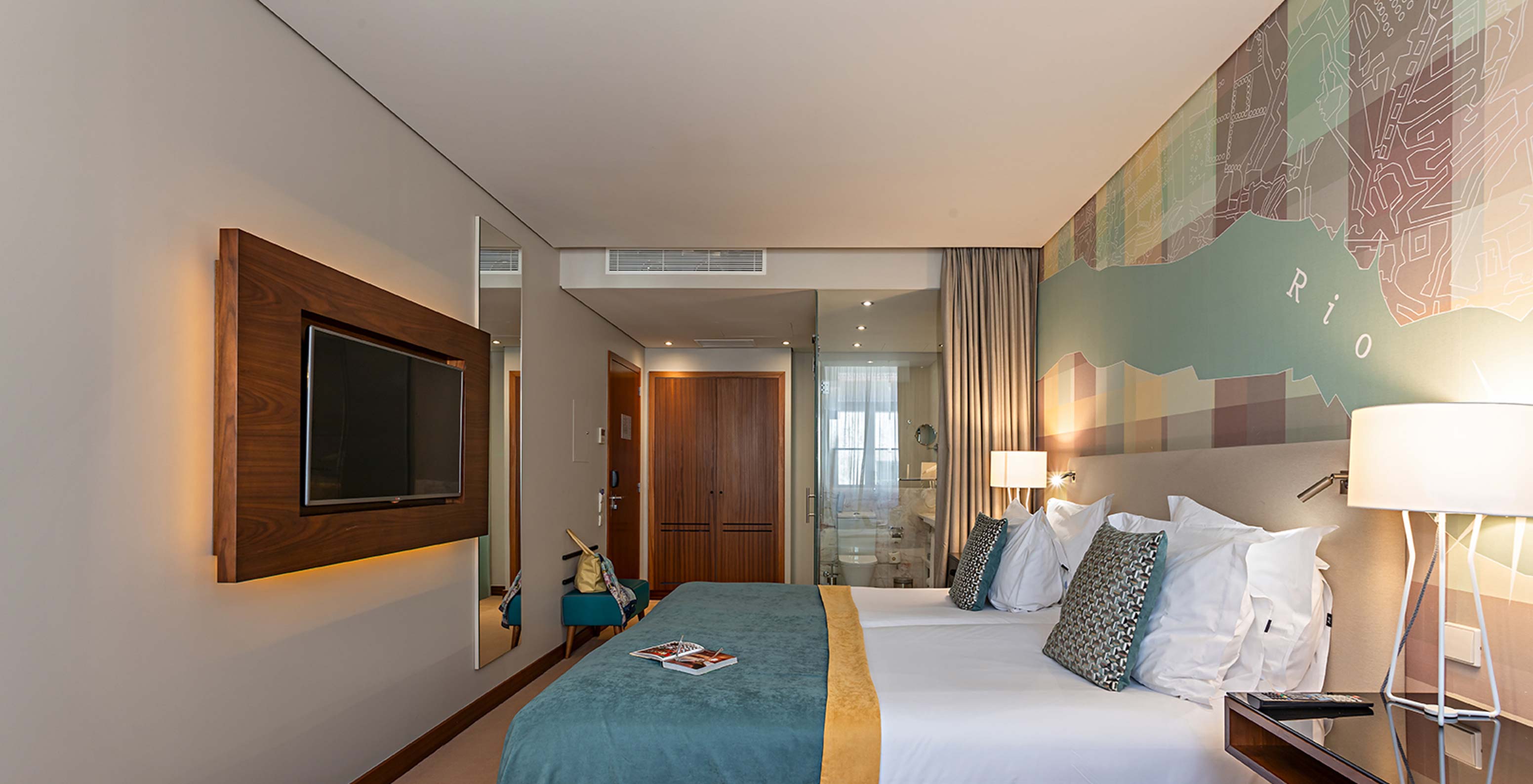 The Superior room at Pestana Vintage Porto has a double bed with a bench at the foot, bedside table and an armchair