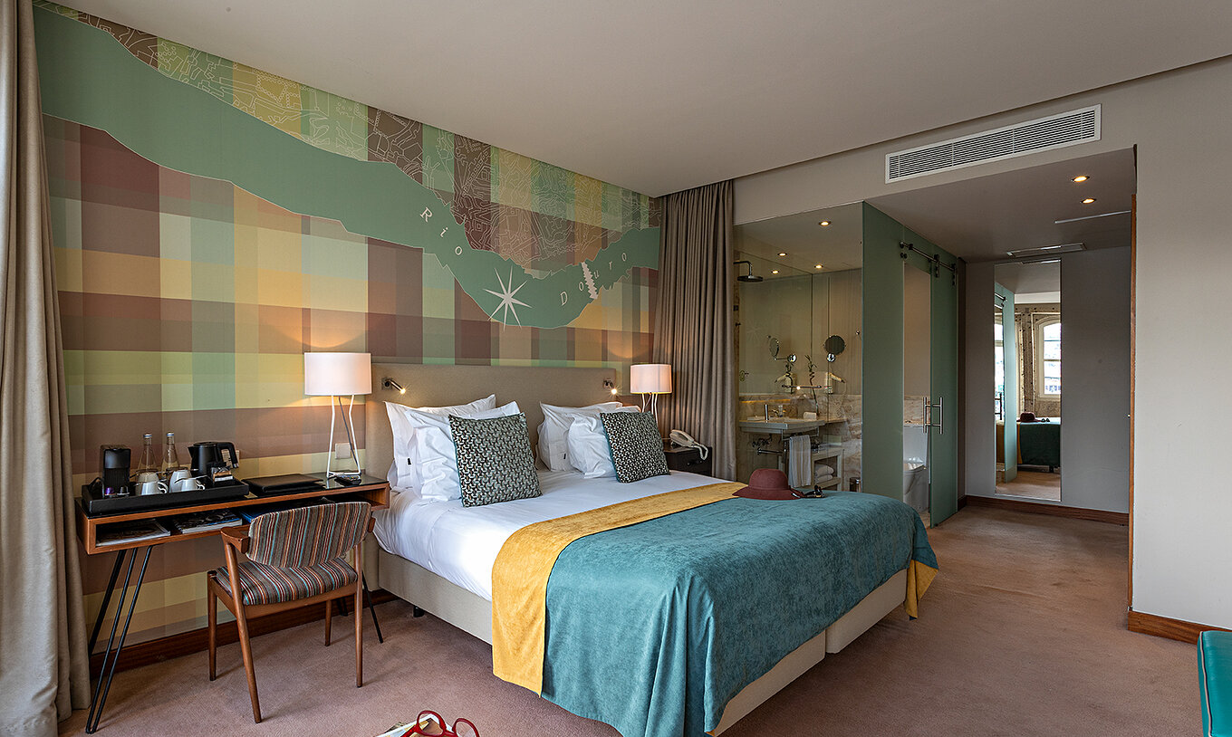 The Vintage River View Balcony at Pestana Vintage Porto has a double bed, a desk and a view of the interior of the bathroom