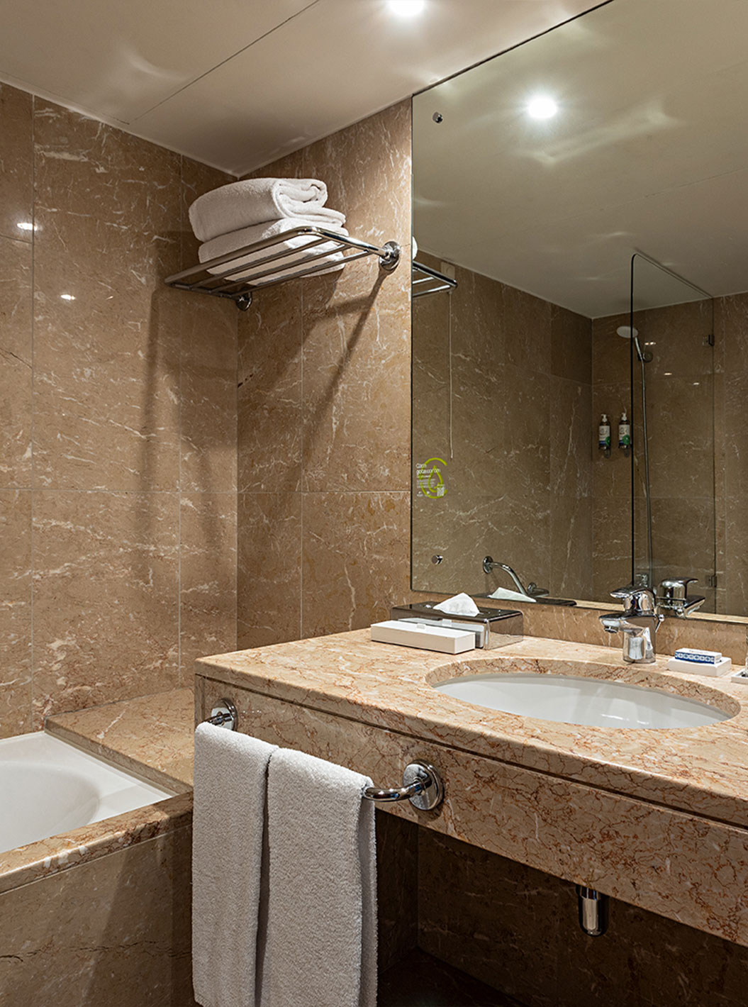 The Vintage River View at Pestana Vintage Porto has a brown marble bathroom with a sink and a bathtub