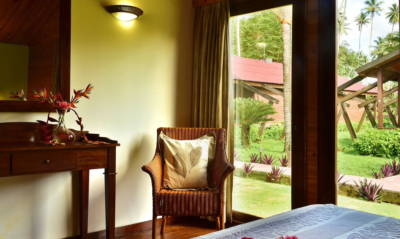 The Standard Double at Pestana Equador Ilheu das Rolas includes a chair and a window with a garden view