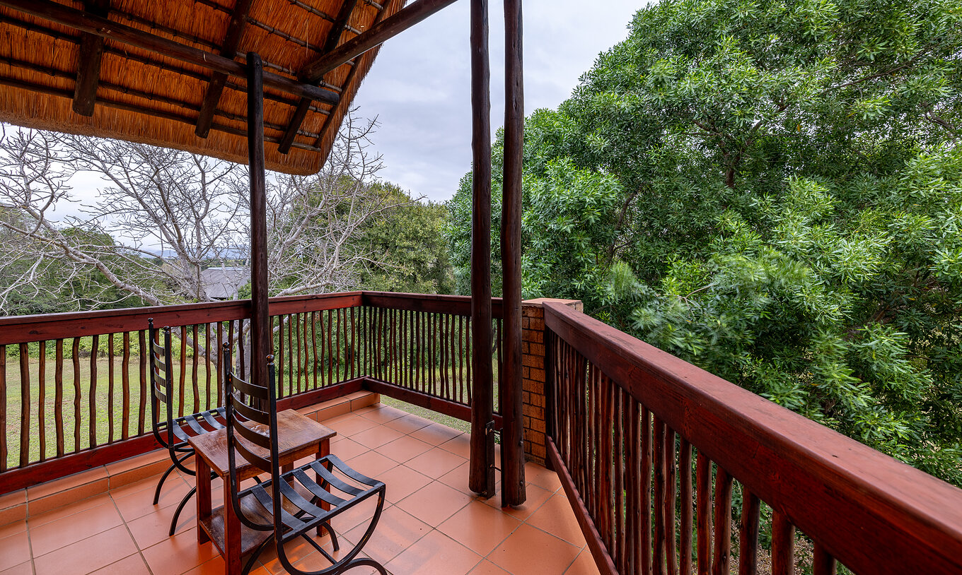 The Classic Room at Pestana Kruger Lodge has a balcony with wooden railing and garden view