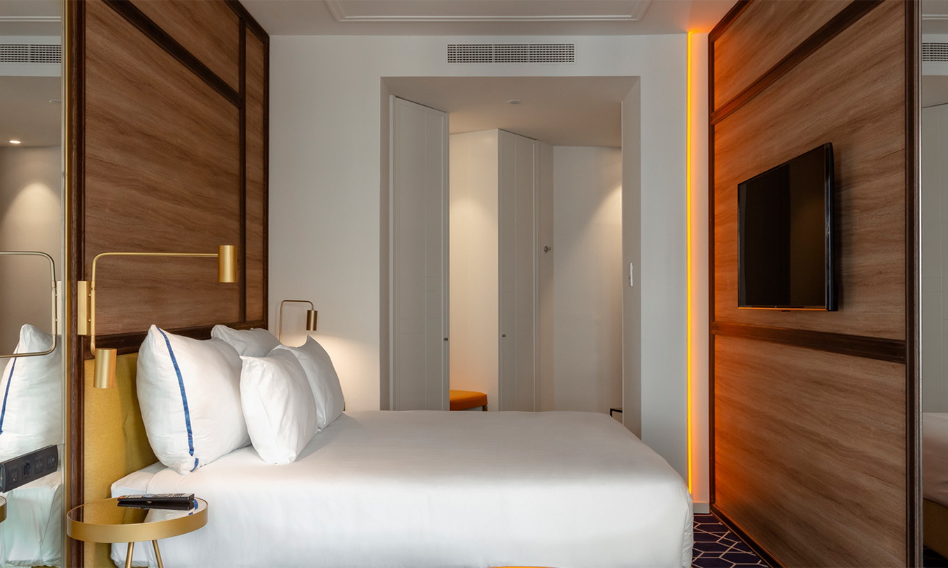 The Amazing CR7 Room at Pestana CR7 Gran Vía Madrid features a double bed, television, hexagonal rug, and entrance door