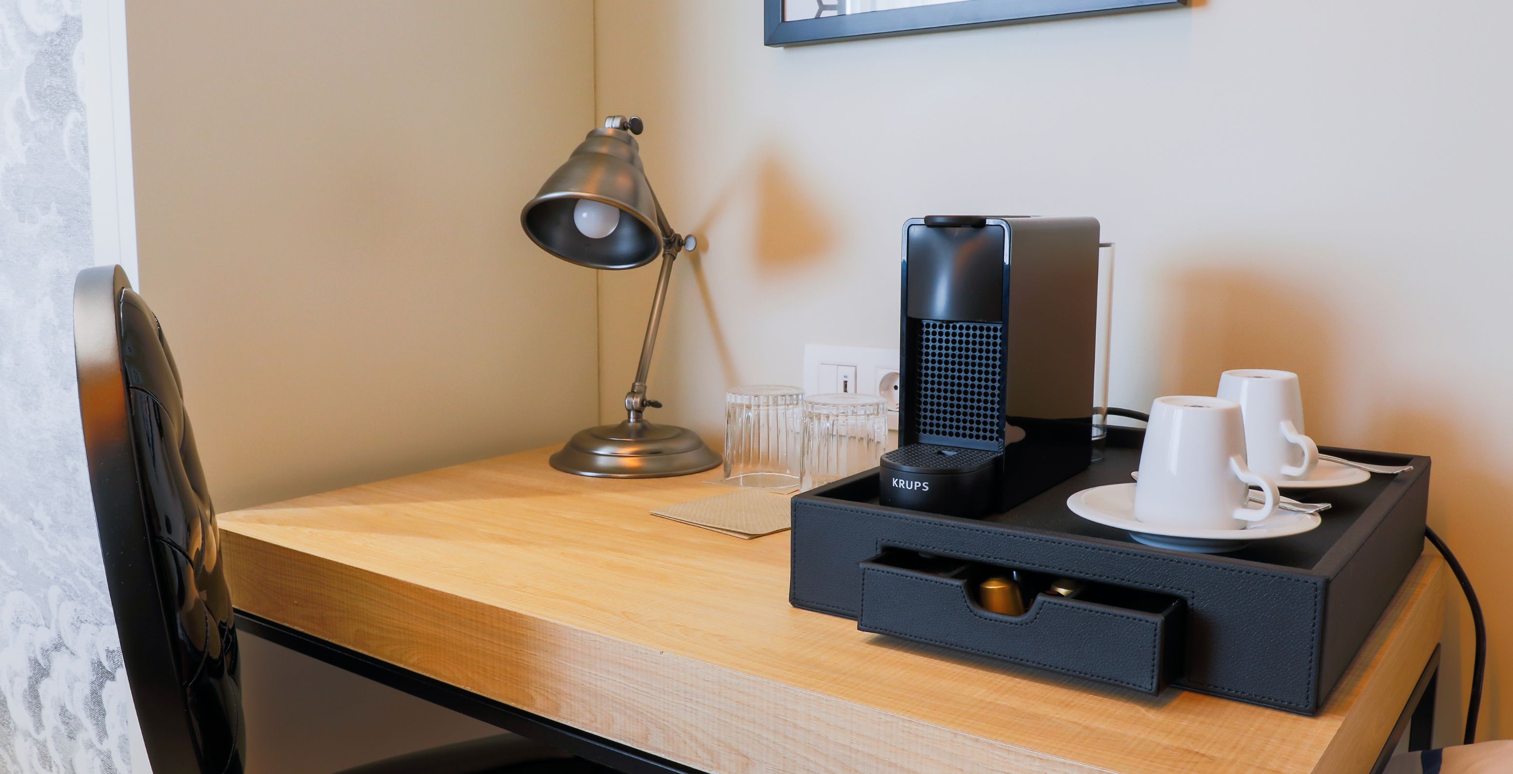 The Superior Plus Room at Pestana Plaza Mayor Madrid has a coffee station with a machine and coffee cups.
