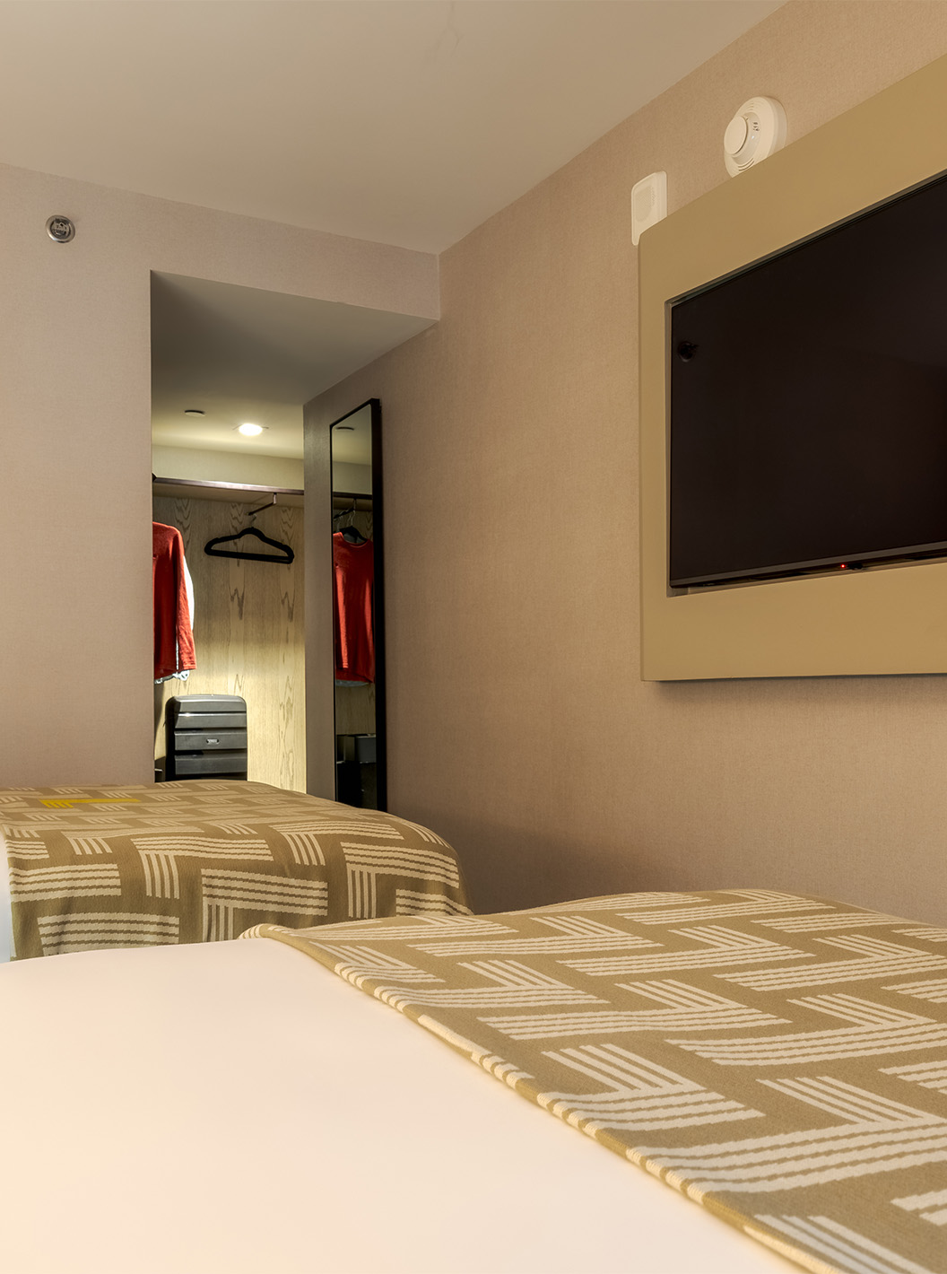 The Comfort Double ADA at Pestana CR7 Times Square has two beds with a bedspread with the number seven and a TV