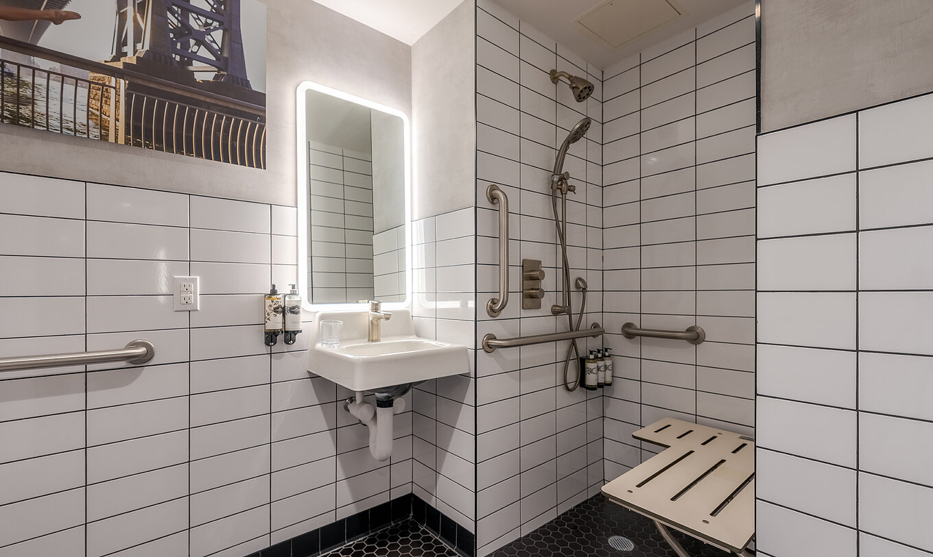 The Superior King High Floor ADA at Pestana CR7 Times Square has an adapted bathroom with sink and shower