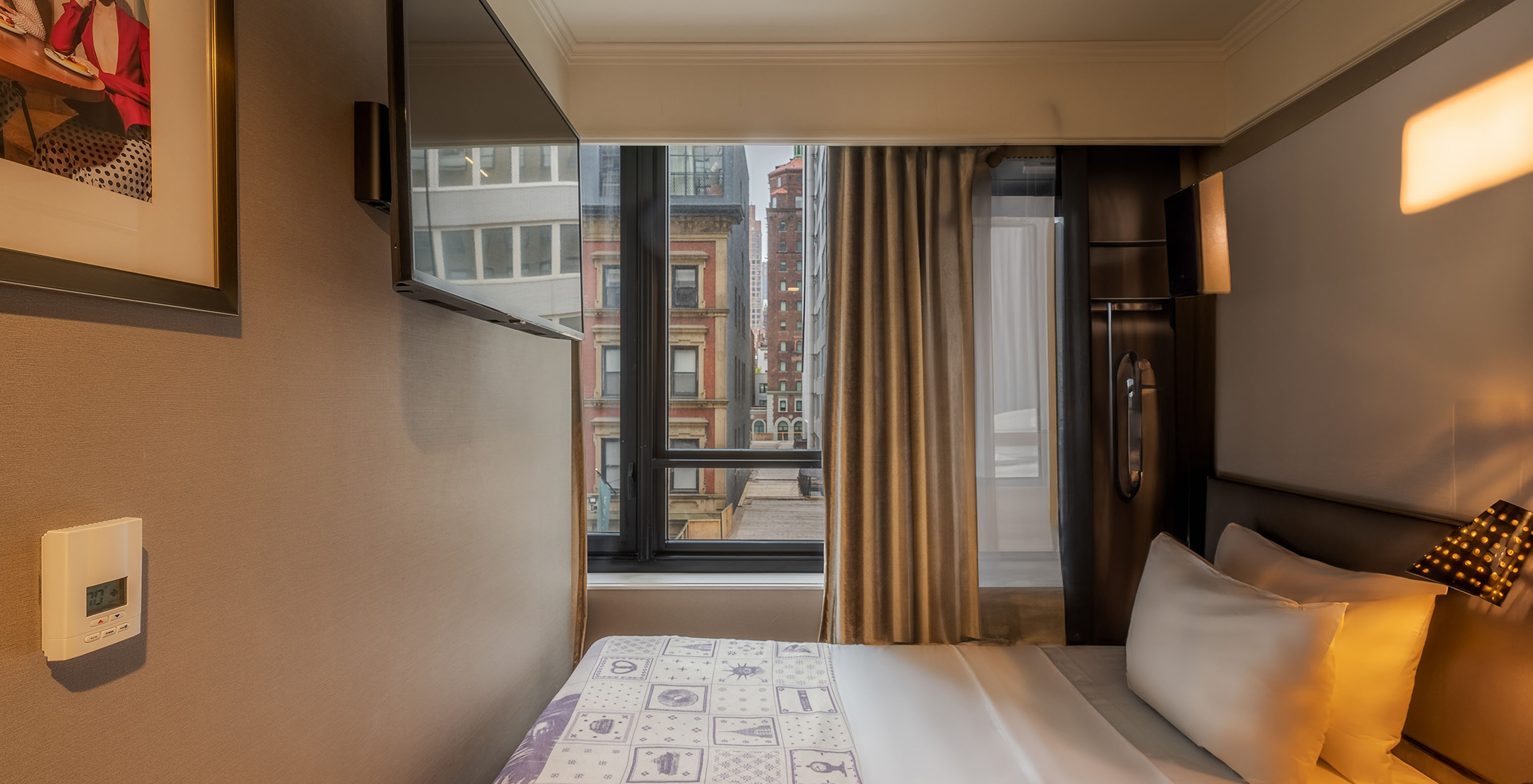 Cabin - ADA at Pestana Park Avenue has a double bed by the window and a television on the wall
