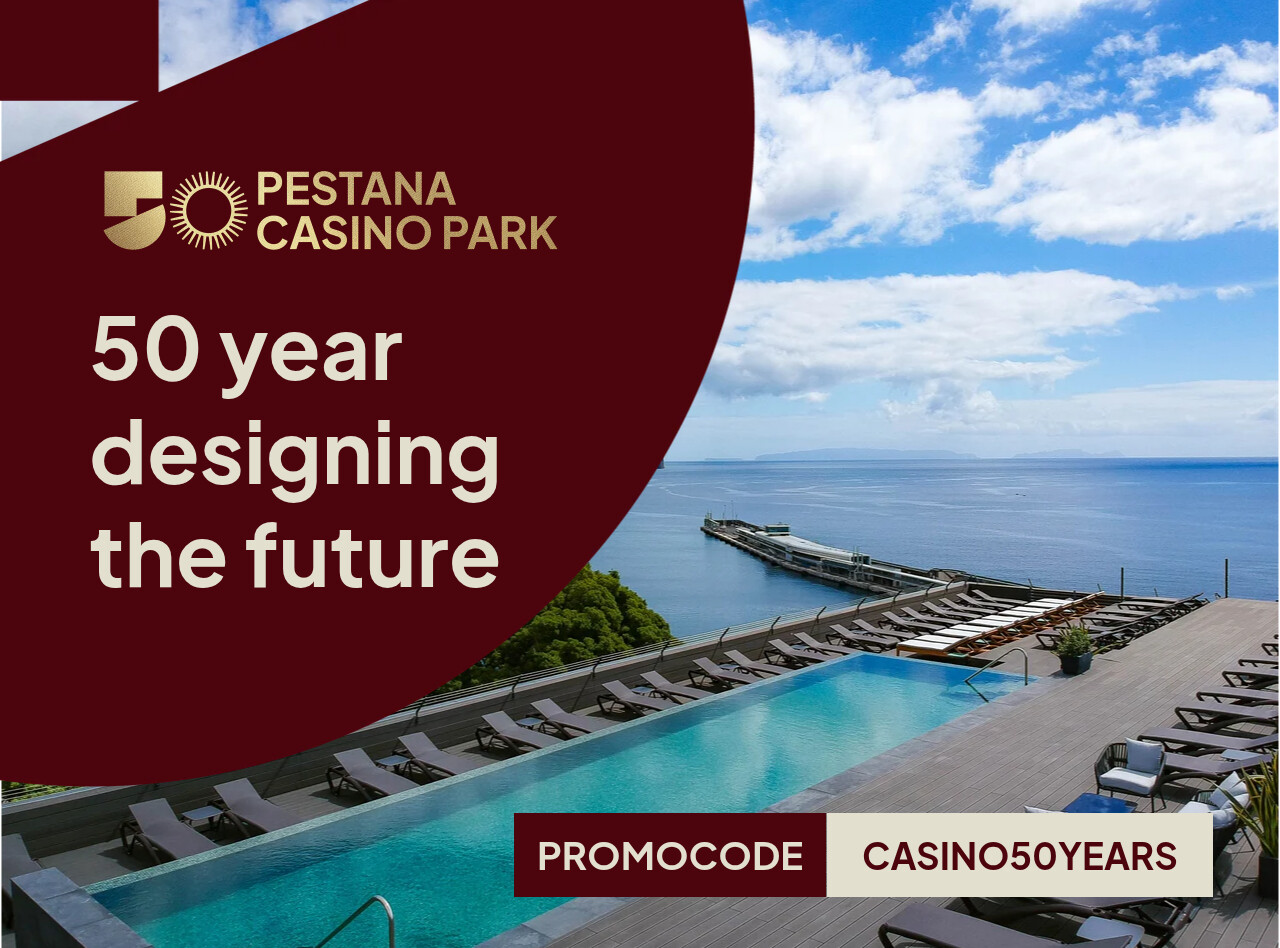 Infinity pool and ocean deck at Pestana Casino Park beside a calm sea under bright clouds and blue sky