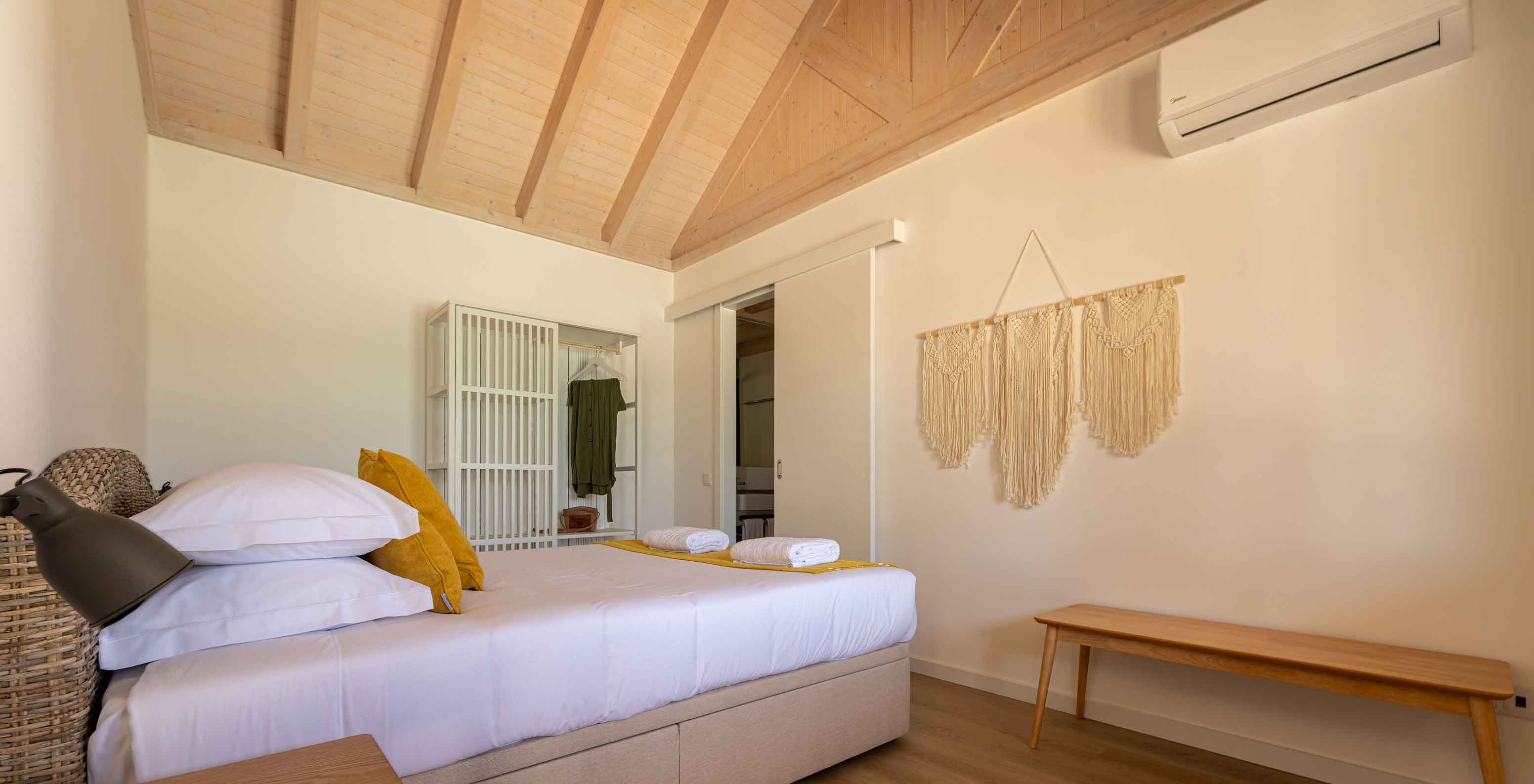 La Premium Green Villa de Pestana Comporta Village Residences tiene un dormitorio con cama, aire acondicionado y decoración