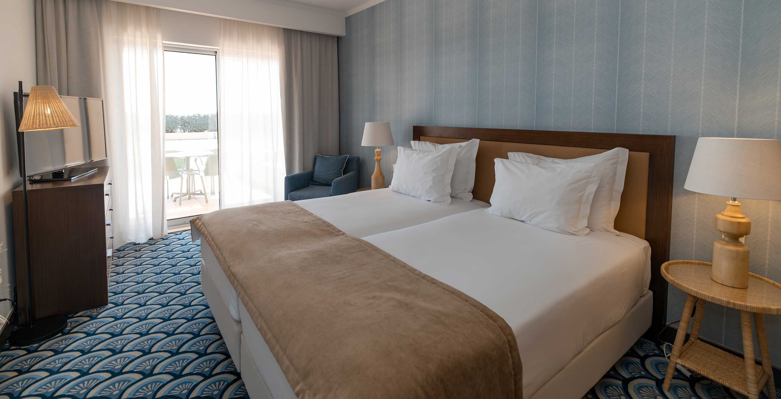 Apartamento T1 Vista Jardín en Pestana Alvor Beach Villas tiene una habitación con dos camas y ventana al balcón
