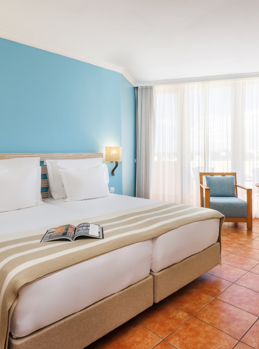 Habitación Deluxe en Pestana Viking con cama doble, sillones junto a la ventana y paredes azul claro