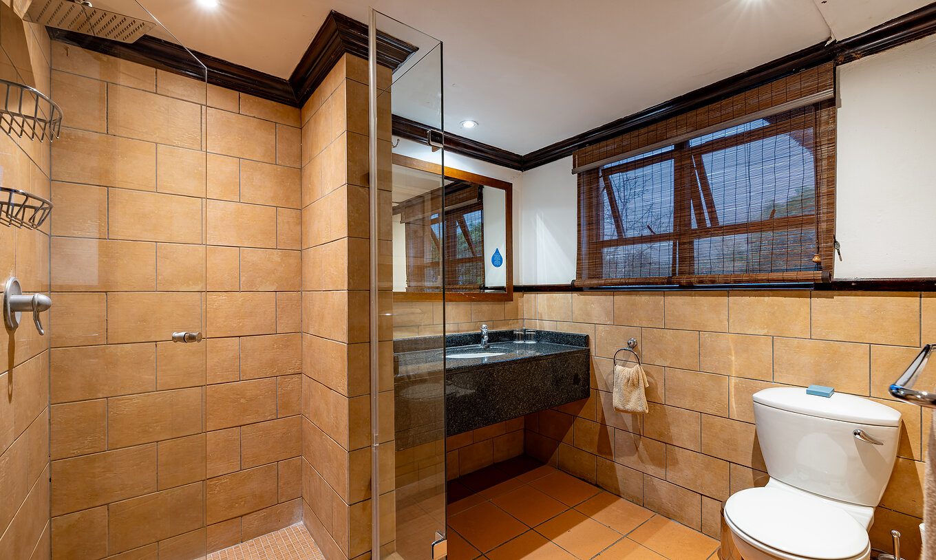 El Quarto Standard del Pestana Kruger Lodge tiene un baño con ducha, lavamanos con espejo, inodoro y ventana con red