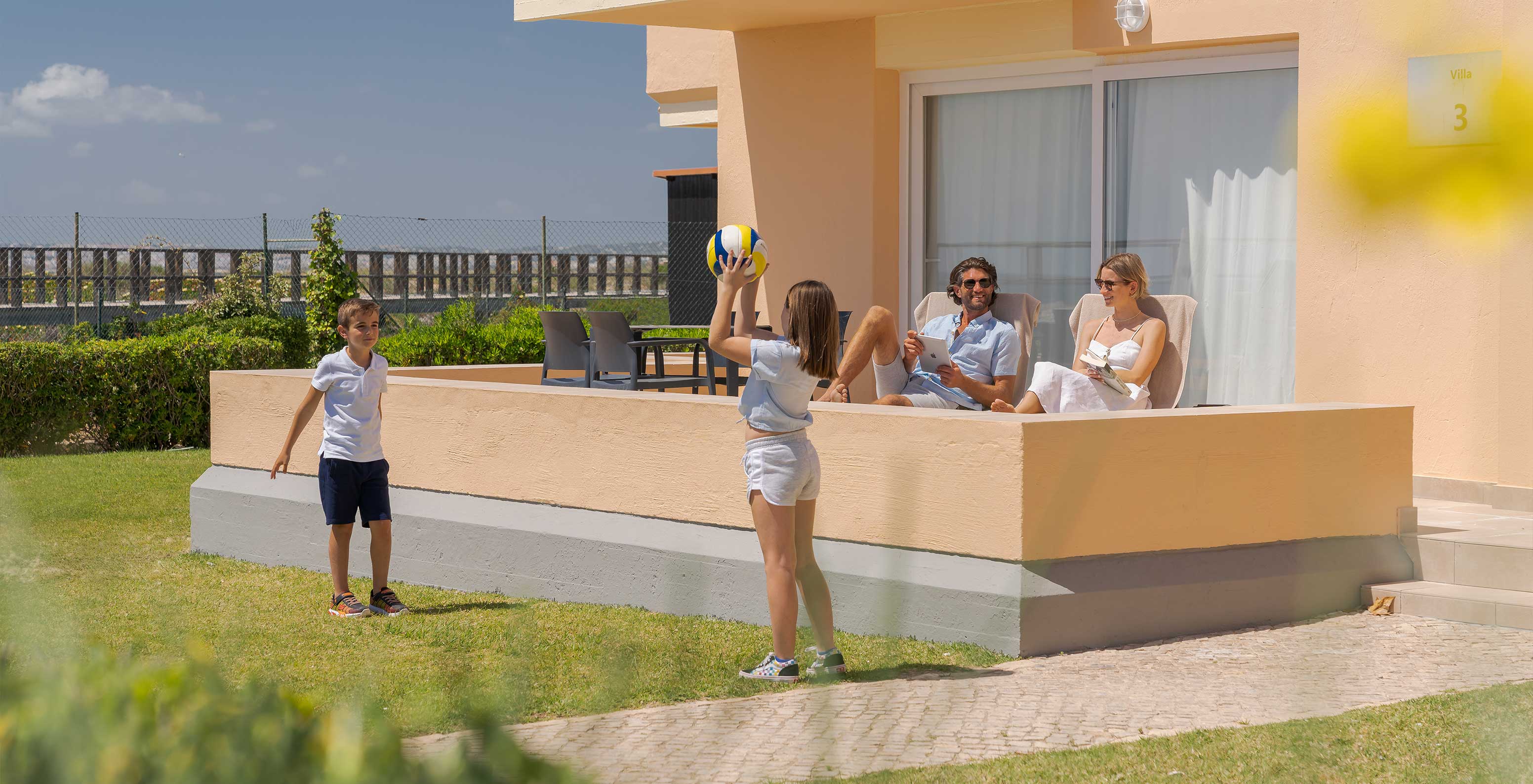 Familia se relaja en su villa y admira el paisaje del mar y el paseo hacia la playa de Alvor