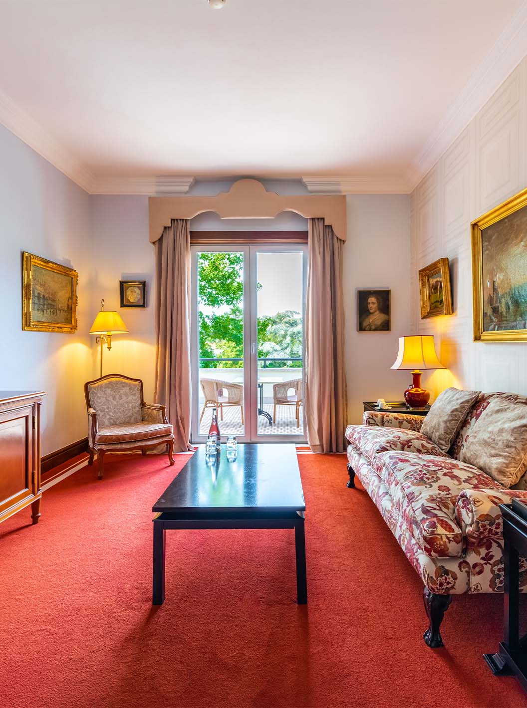La Suite Collection del Pestana Palace Lisboa tiene una sala con sofá, televisión, ventana con terraza y cuadros en la pared