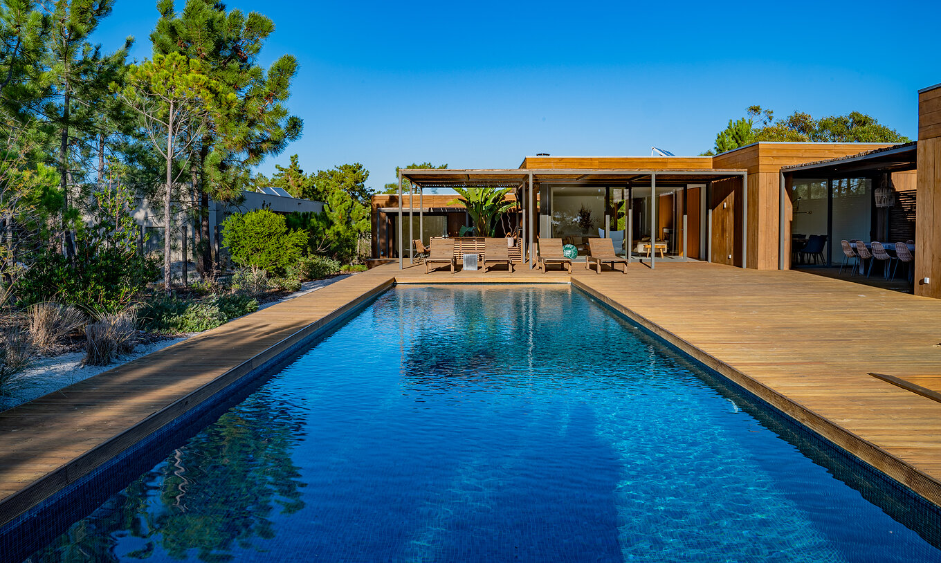 Les Deluxe Villas avec piscine privée du Pestana Tróia Eco Resort ont une grande piscine avec plusieurs chaises longues
