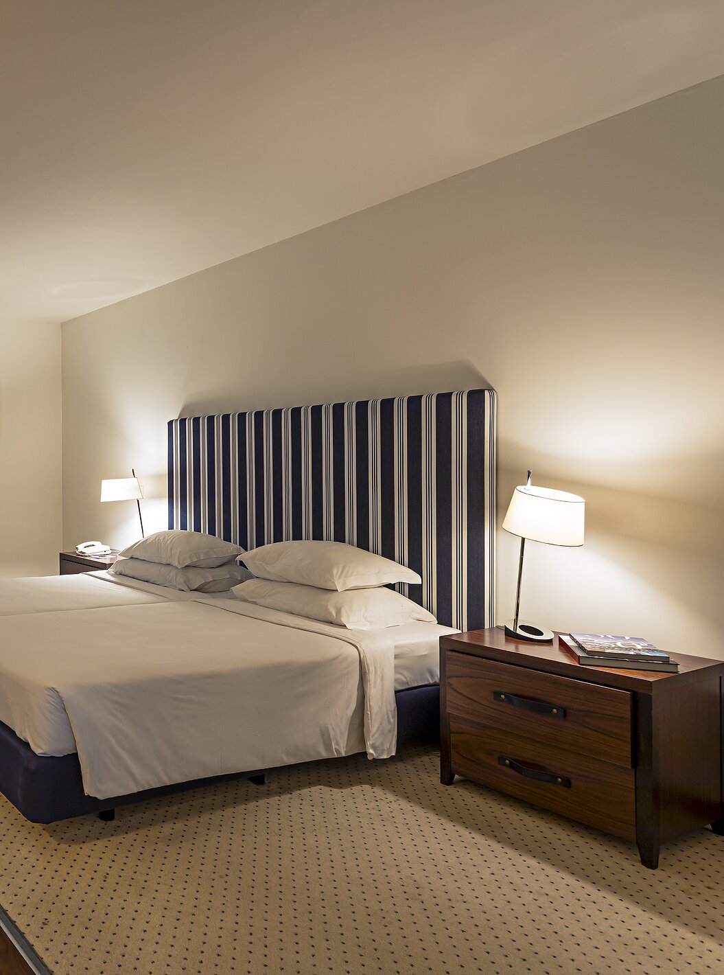 La suite Cliff T2 du Pestana Alvor Praia a une grande chambre avec lit double, deux tableaux et une commode avec TV