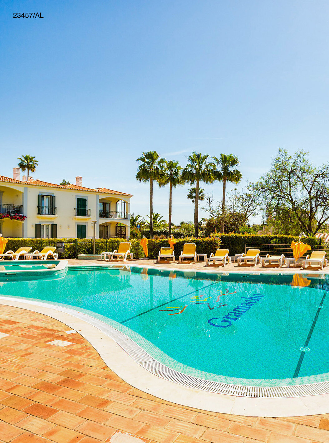 L'appartement Pestana Carvoeiro Golf T3 Standard dispose d'un espace extérieur avec une piscine et des chaises longues jaunes