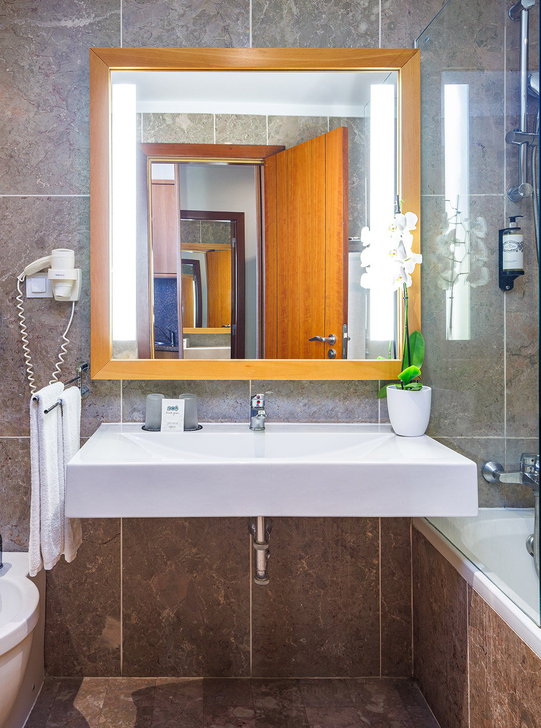 Chambre Deluxe vue latérale sur la mer au Pestana Viking, salle de bain en marbre avec grand miroir éclairé