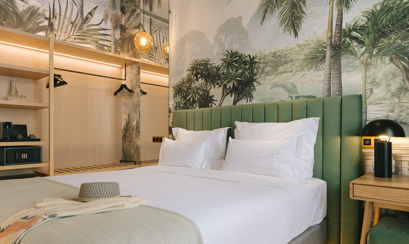 La chambre Supérieure du Pestana Rua Augusta Lisboa a un lit double, une table de nuit et une armoire ouverte