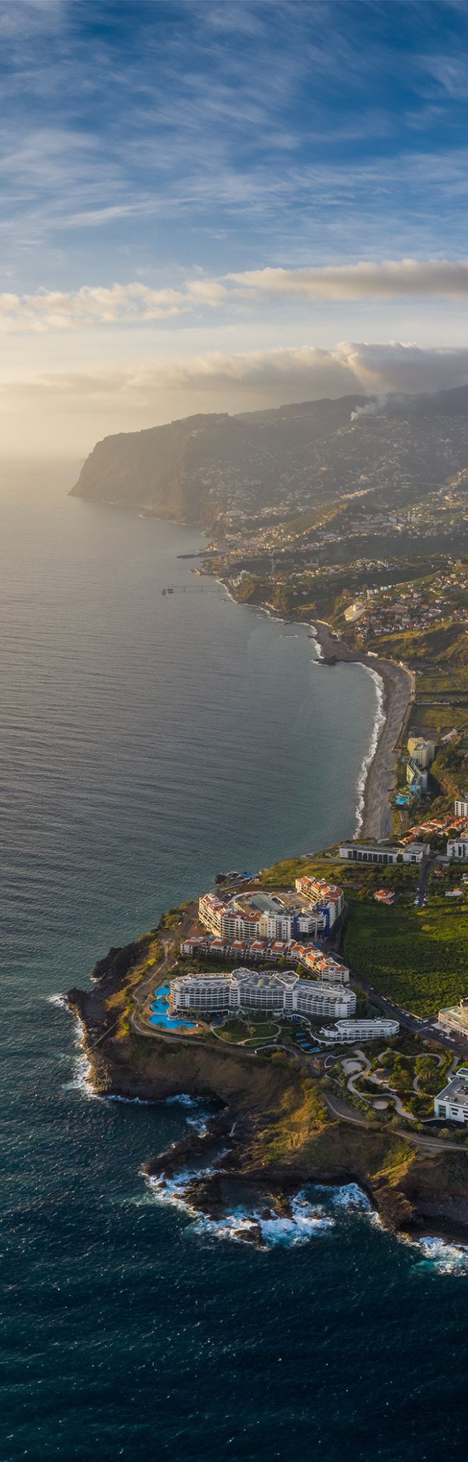Vue aérienne de la ville de Funchal, à Madère, avec des zones urbaines denses et des montagnes en arrière-plan