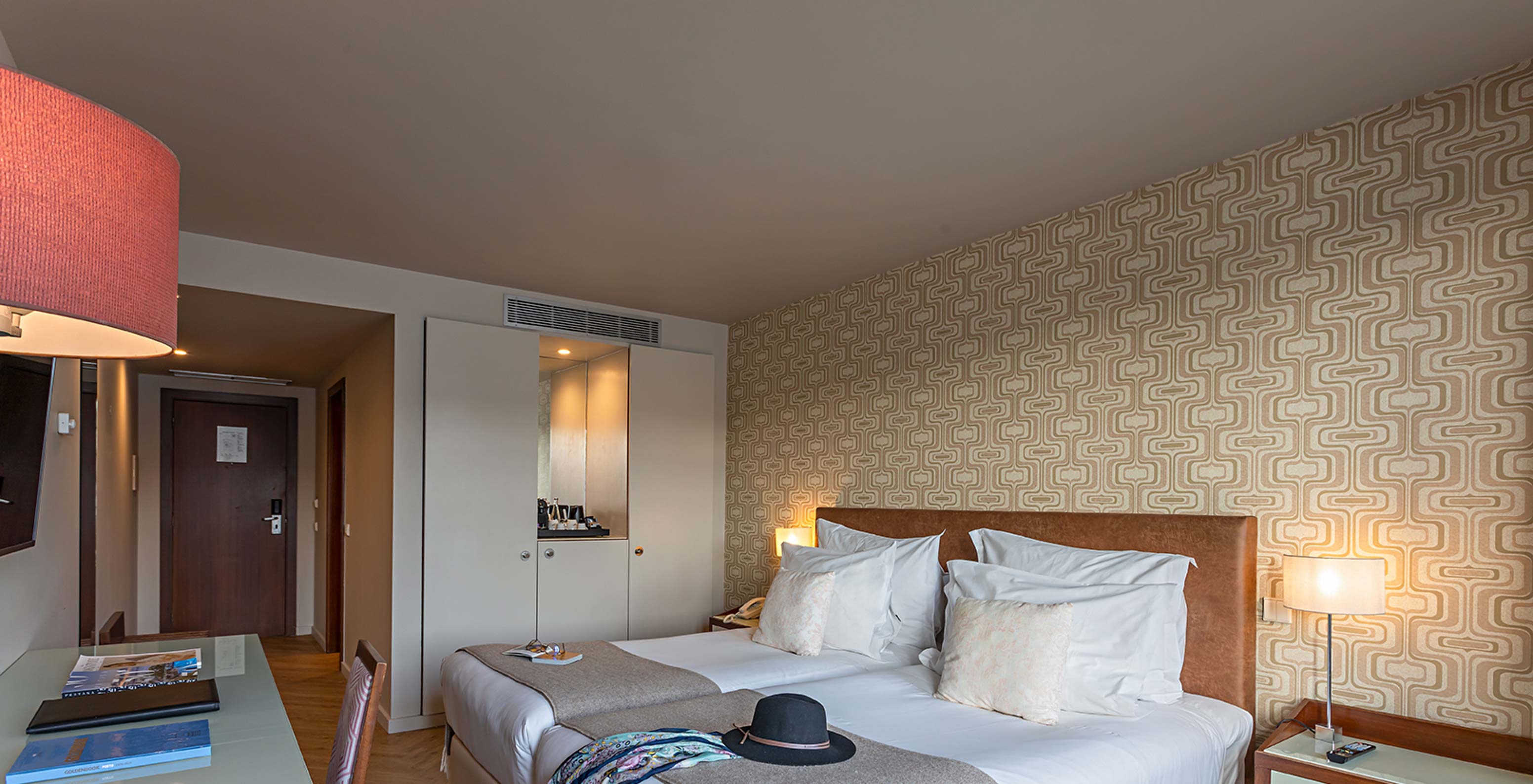Le Vintage River View du Pestana Vintage Porto a un lit double avec une couverture jaune et bleue, et papier peint coloré
