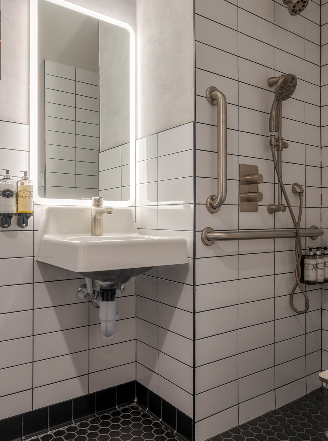 Le Comfort Double ADA du Pestana CR7 Times Square a une salle de bain adaptée avec douche, lavabo et miroir
