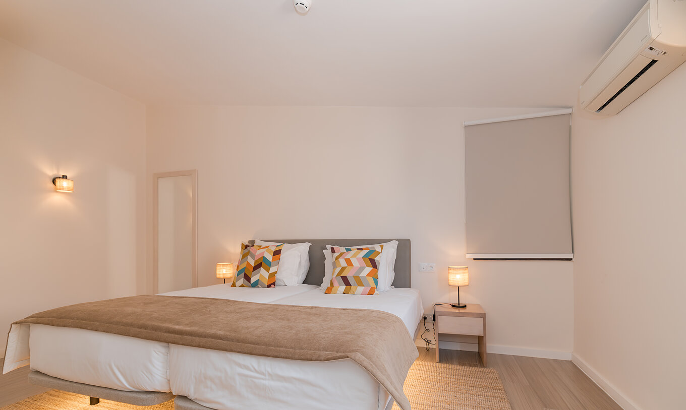 Villa 2 Slaapkamers Premium bij Pestana Alvor Beach Villas heeft kamer met twee bedden, nachtkastje en airco
