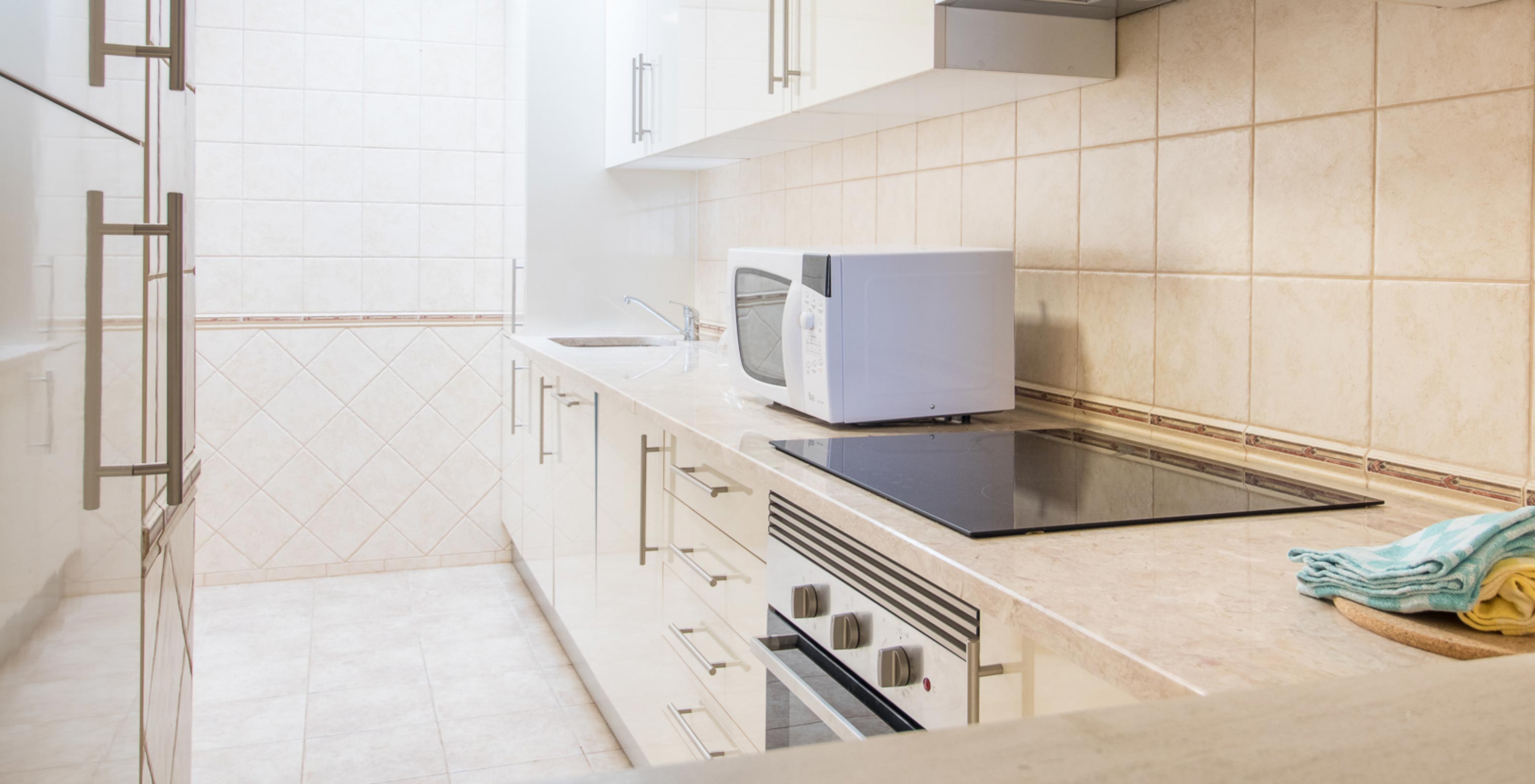 Het éénslaapkamerappartement bij Pestana Gramacho heeft een eenvoudige keuken met apparaten en neutrale stijl