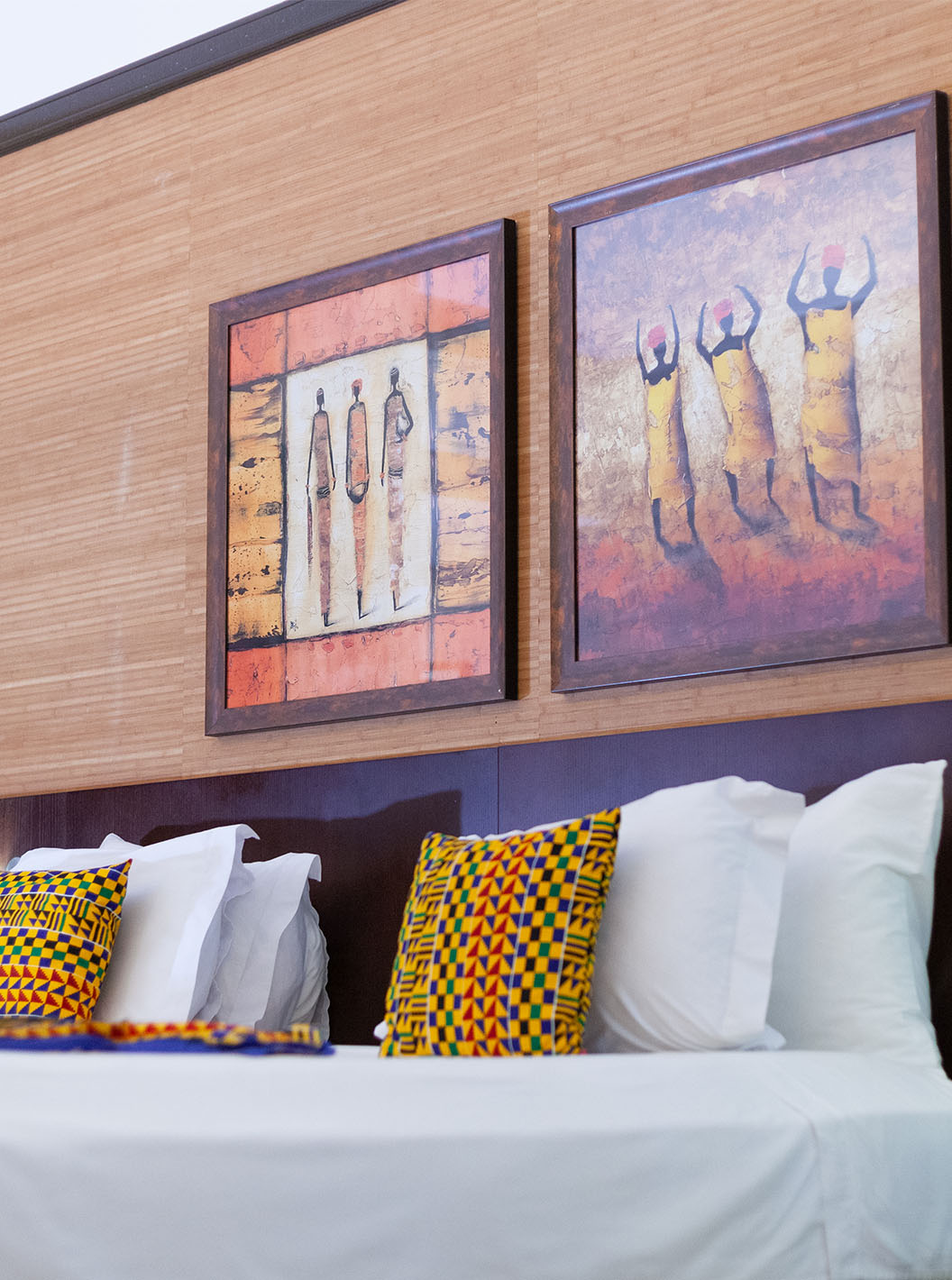 O quarto Premium do Pestana Tropico conta com dois quadros de arte por cima da cama de casal, e uma mesa de cabeceira