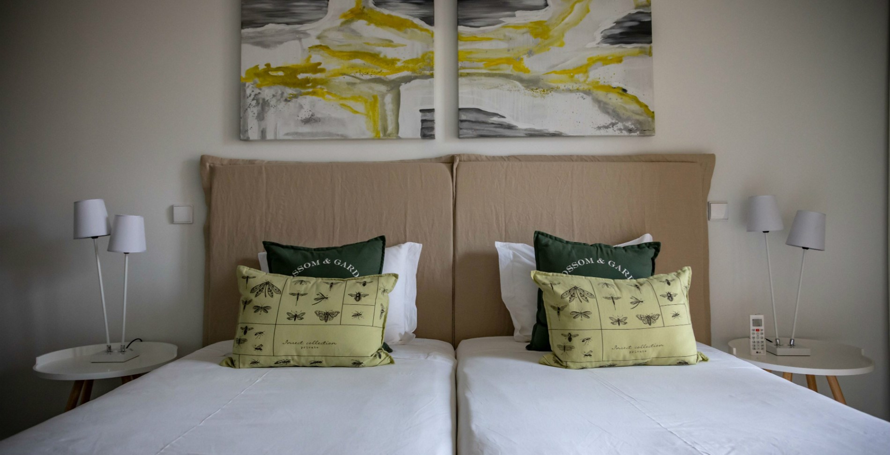 O Apartamento Eco Village Rés do Chão do Pestana Tróia Eco Resort tem duas camas juntas e quadros na parede