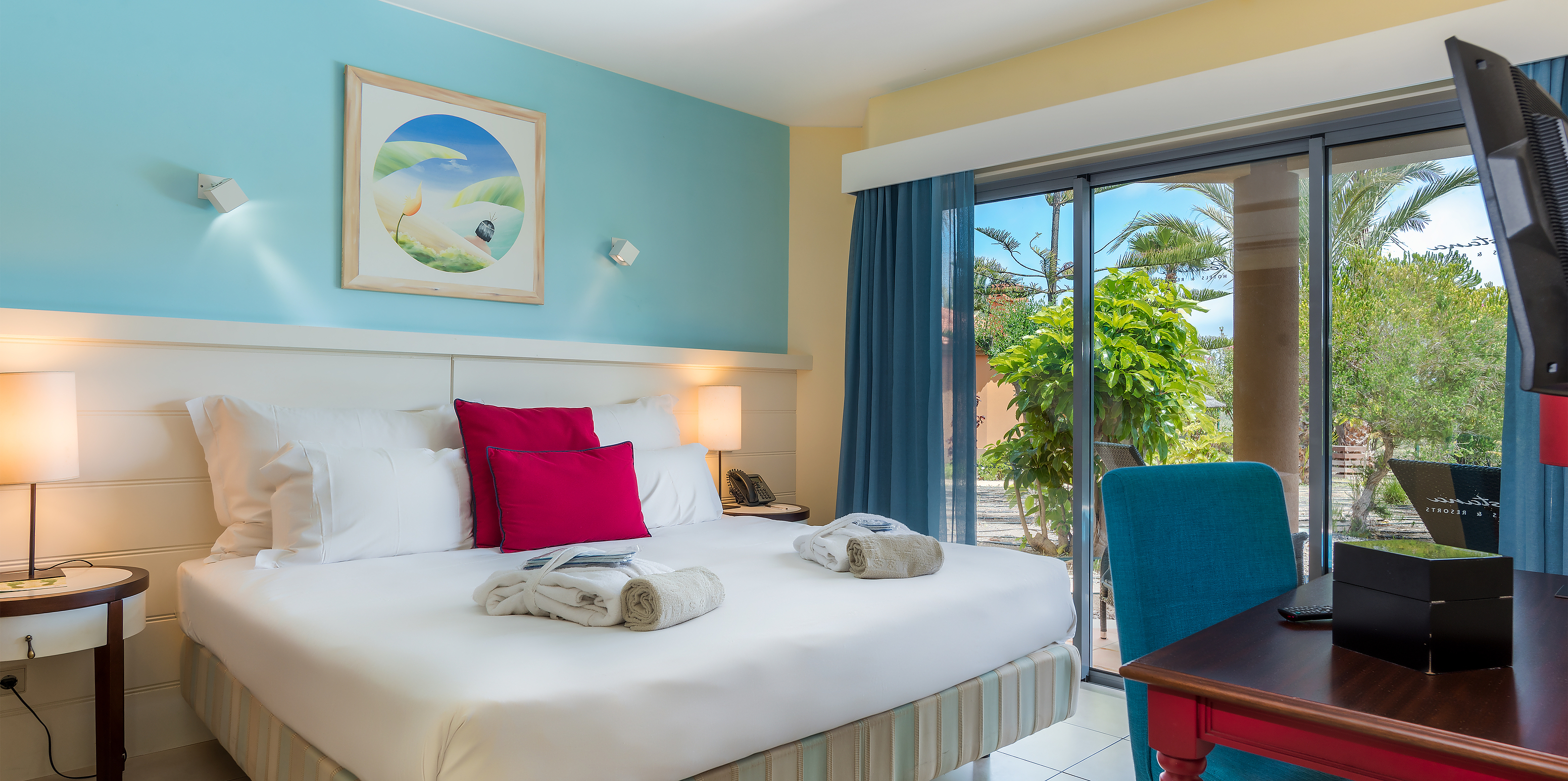 A Pool Villa do Pestana Porto Santo All Inclusive tem um quarto em tons de azul, com cama de casal e uma janela grande