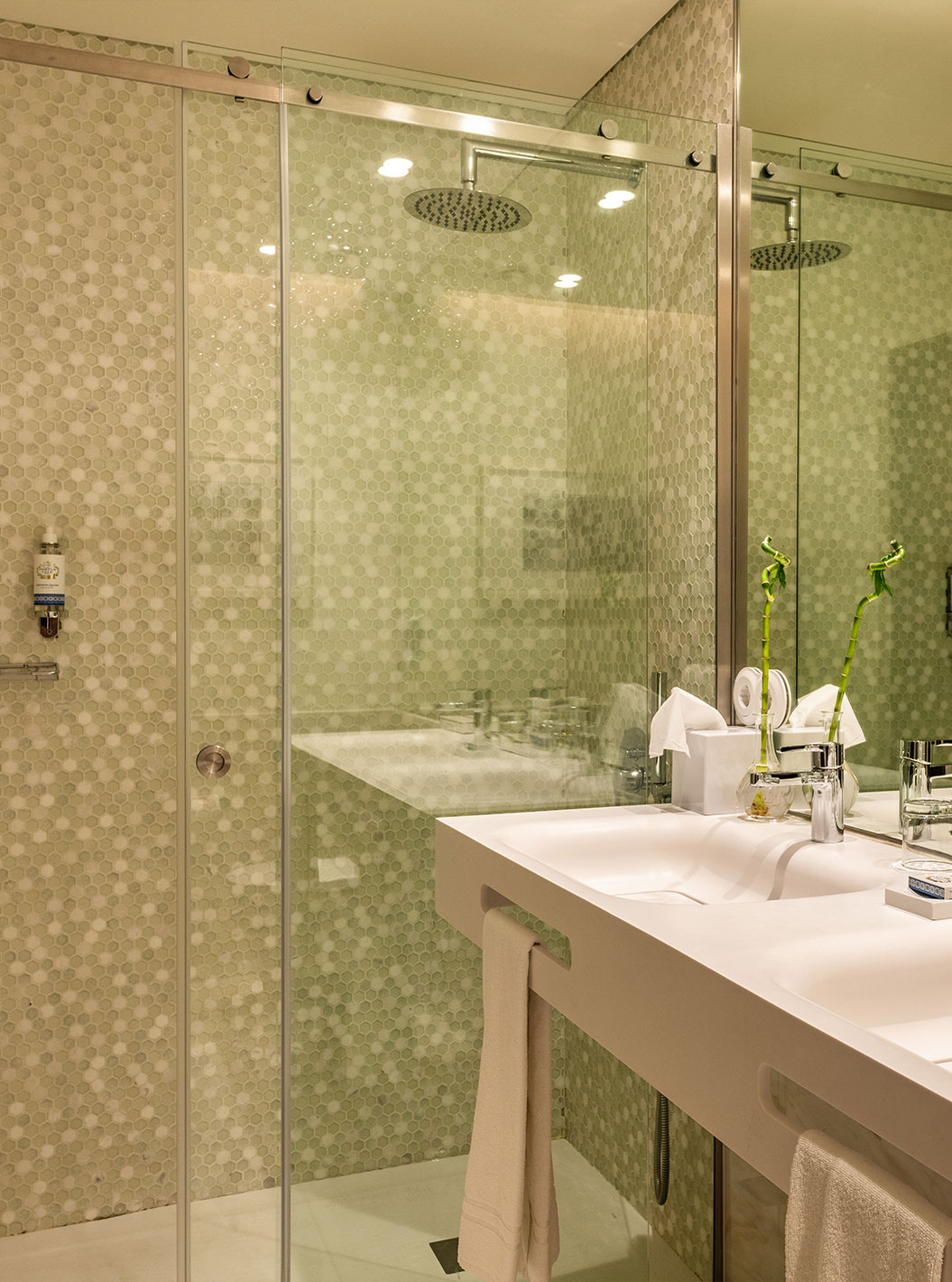 O Executive Deluxe do Pestana Porto - A Brasileira tem um duche com uma porta de vidro e dois lavatórios brancos