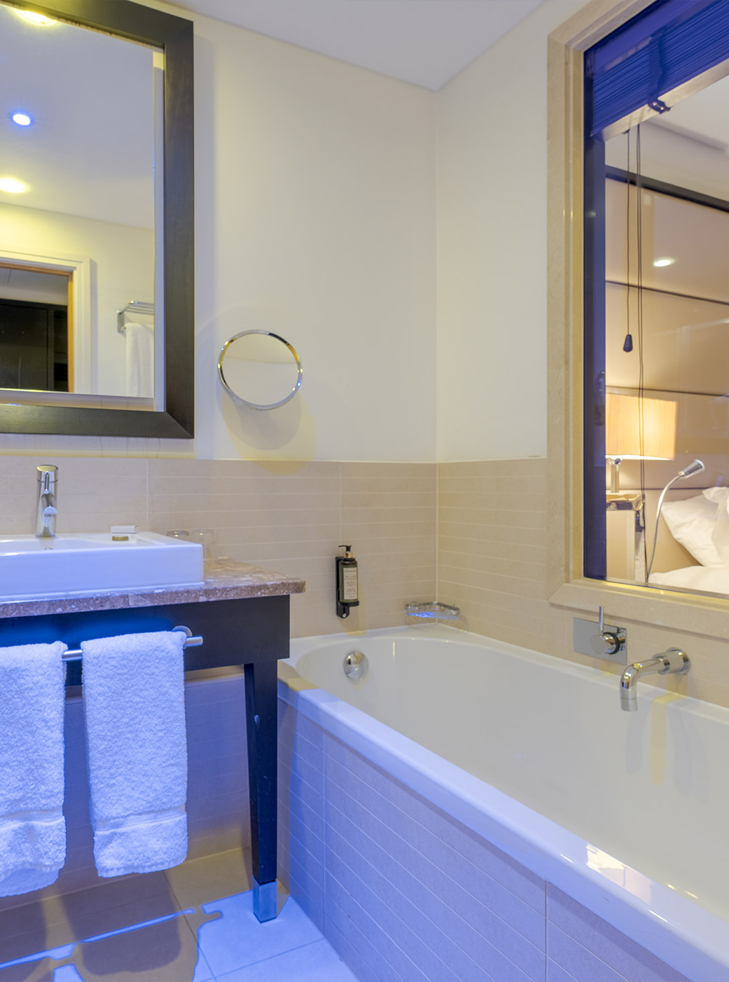 O Premium King do Pestana Chelsea Bridge tem casa de banho com banheira, vidro para o quarto, lavatório, espelhos e secador