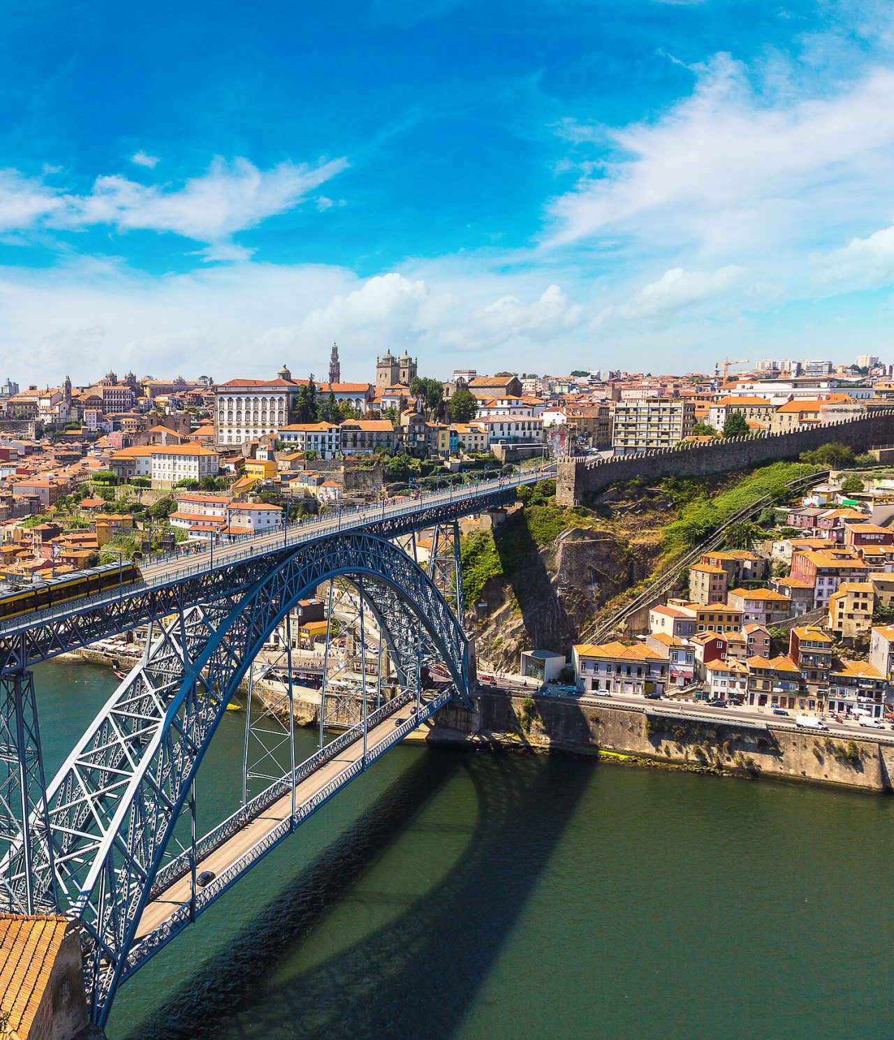 Luftaufnahme der Dom-Luís-I-Brücke über dem Douro-Fluss, mit der Stadt Porto und ihren historischen Gebäuden im Hintergrund