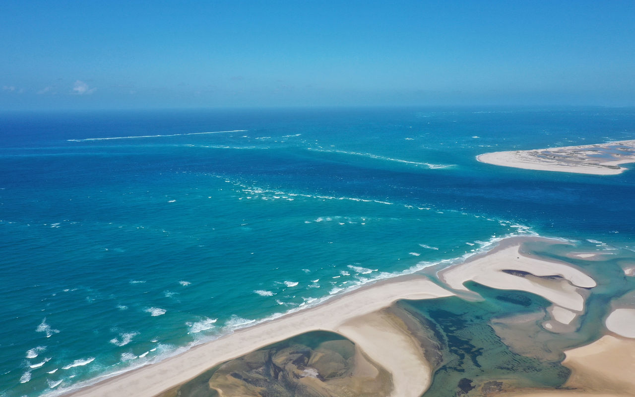 Stunning aerial view of Bazaruto Bay, with crystal-clear waters, white sand dunes, and coral reefs