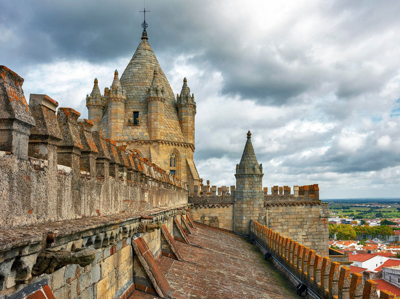 Explore Hotels in Alentejo featuring medieval stone towers and castle walls beneath dramatic clouds