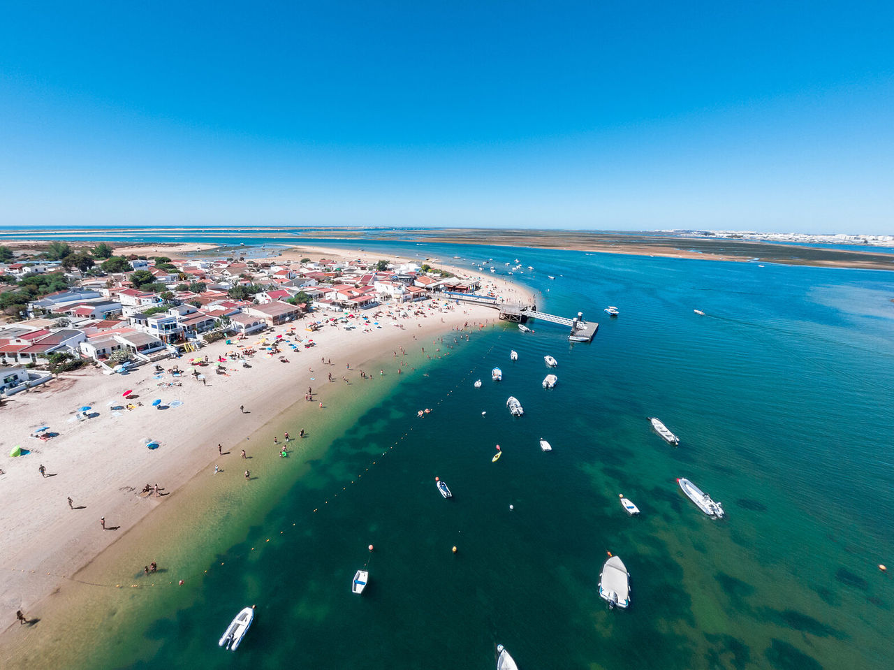 Aerial paradise view of Armona Island, Algarve, with crystal-clear waters and boats in Ria Formosa