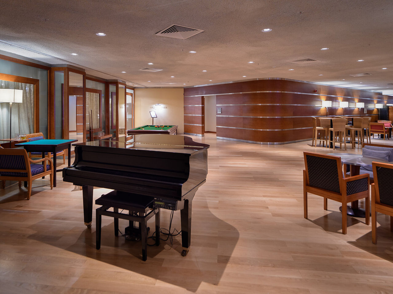 Restaurant and bar at Pestana Vila Sol, a 5-Star Hotel in Vilamoura, featuring a spacious lounge with piano, pool table, and seating areas