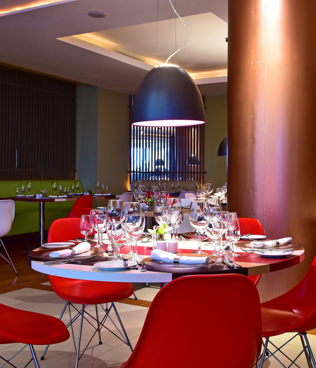 Deep Blue Restaurant, at a 4-Star Hotel by the Sea in Funchal, has round table with red chairs