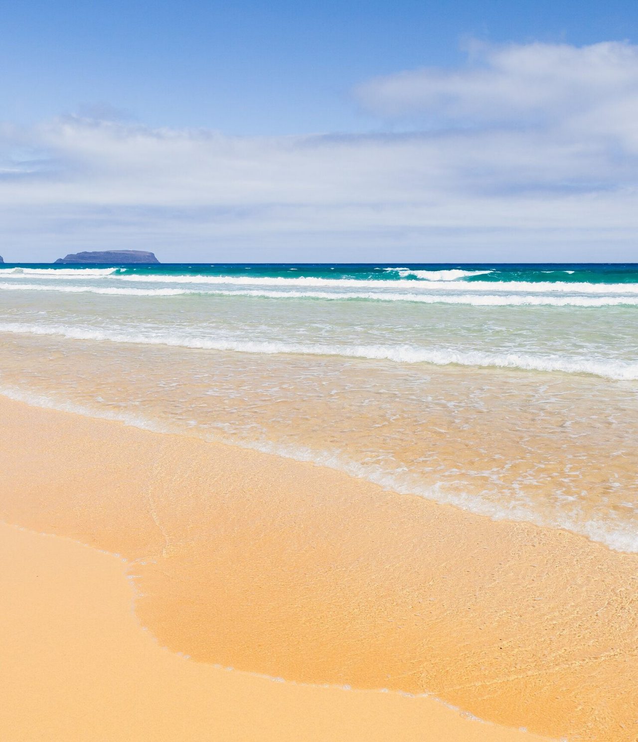 View of Porto Santo beach, in front of Pestana Porto Santo, with golden sand and turquoise blue water