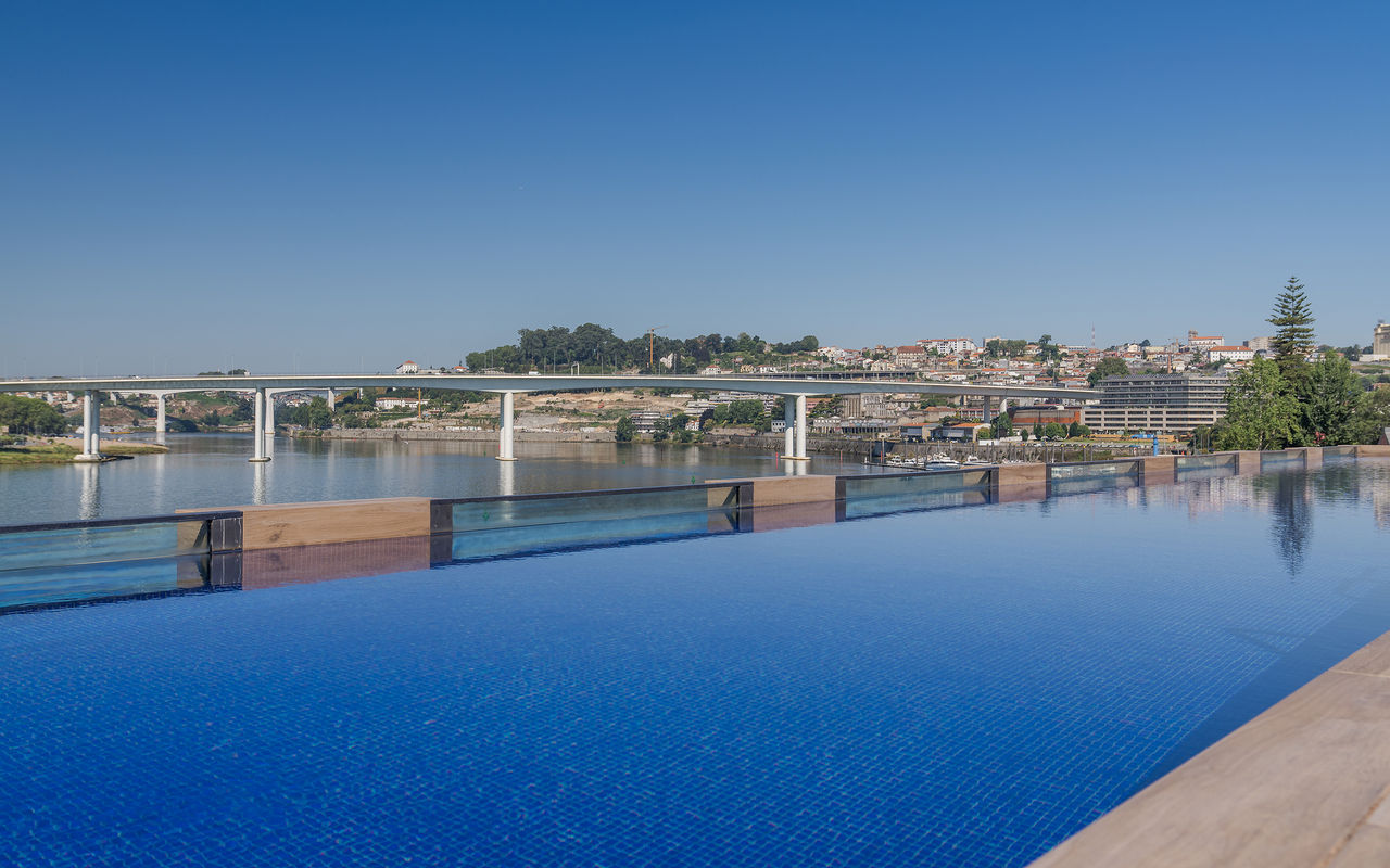View of the outdoor pool of Pestano Douro, with the Douro River in the background