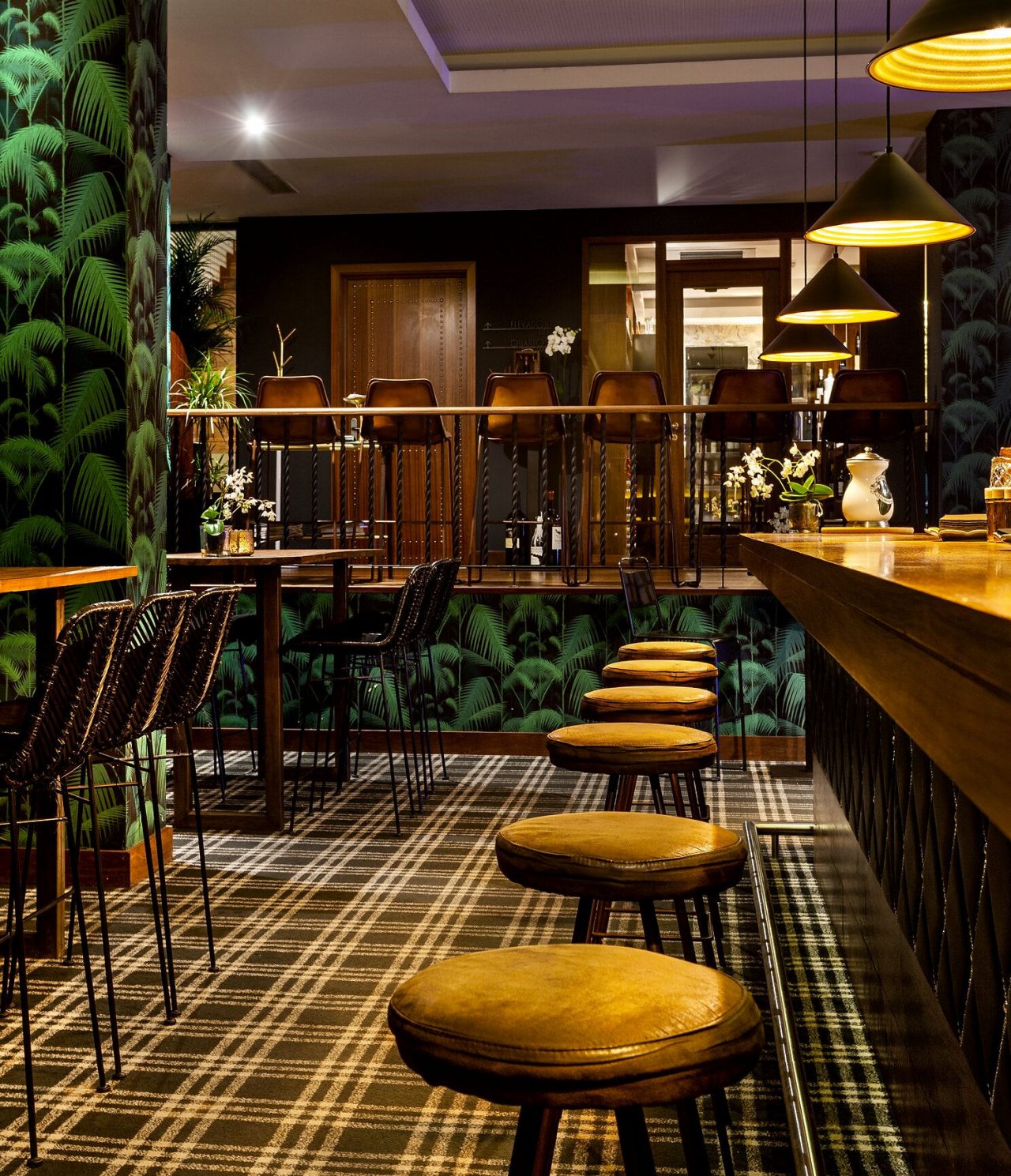 The Rib Bar, of the 5-Star Hotel in the Center of Porto, has a counter with high stools and tropical wallpaper
