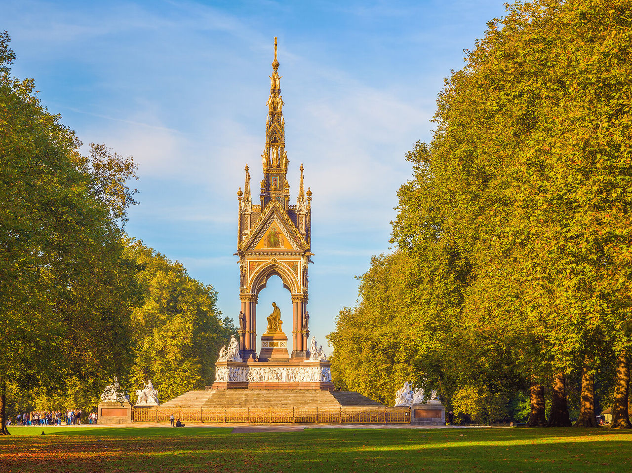 Explore Hotels in London featuring the Albert Memorial framed by green lawns and tall autumn trees near Hyde Park
