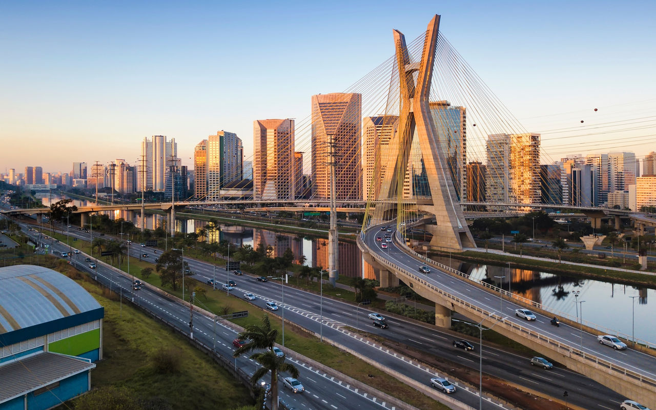 Urban landscape of São Paulo with the Estaiada Bridge crossing the Pinheiros River under a blue sky