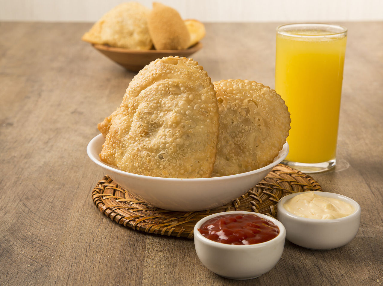 Typical São Paulo pastry with tomato sauce and mayonnaise, accompanied by orange juice