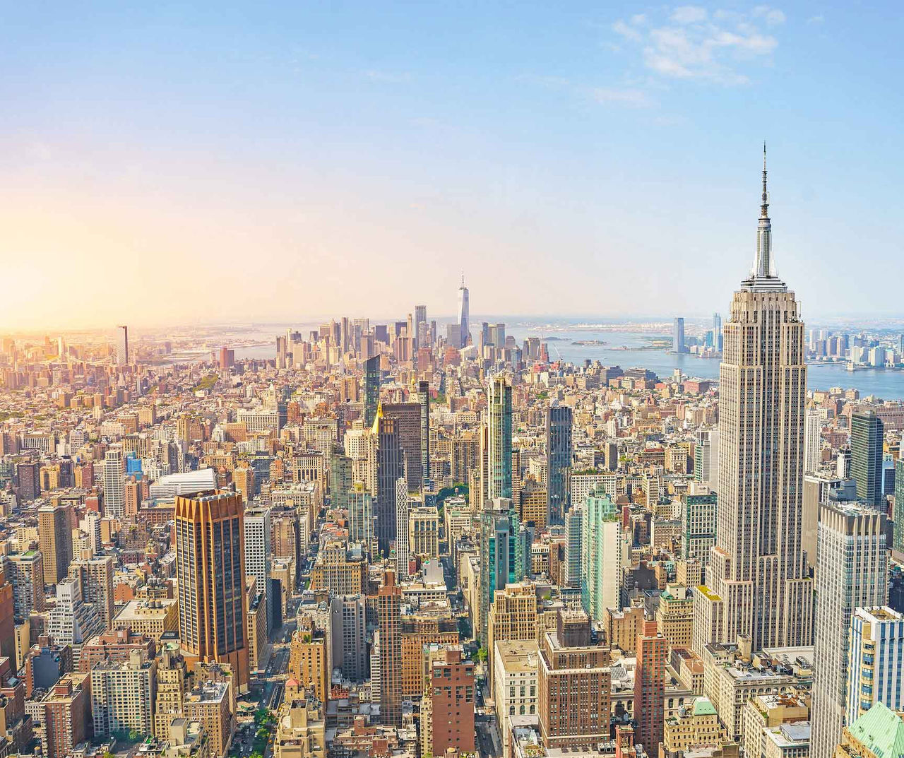 new-york hotel featuring an aerial view over Manhattan skyscrapers and the Empire State Building at sunset