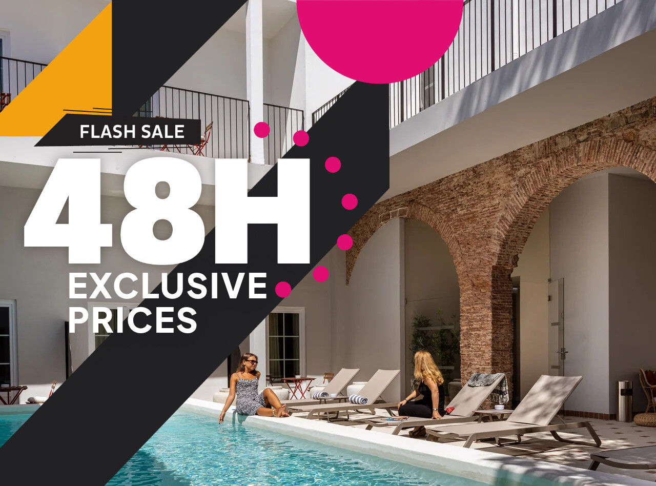 Guests relaxing beside an indoor courtyard pool with arches and a large 48H exclusive prices flash sale graphic