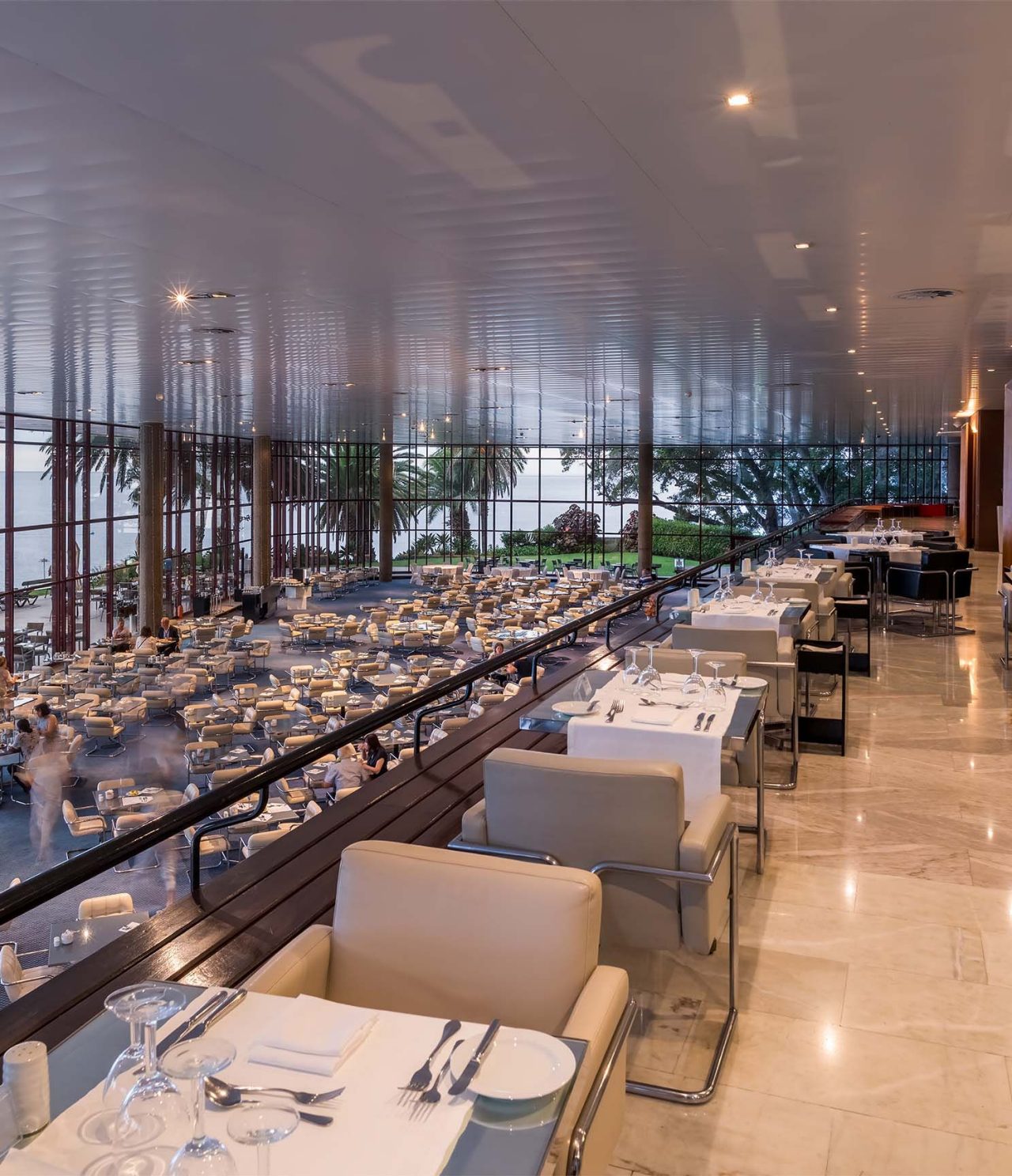 Le restaurant Panorâmico de l’hôtel à Funchal, sur l’île de Madère, a deux étages de tables avec chaises rembourrées
