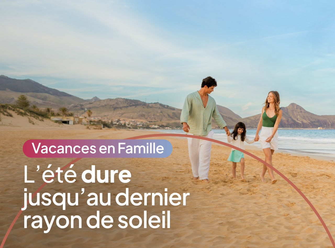 Famille marchant main dans la main sur une plage de sable au coucher du soleil avec montagnes en arrière-plan