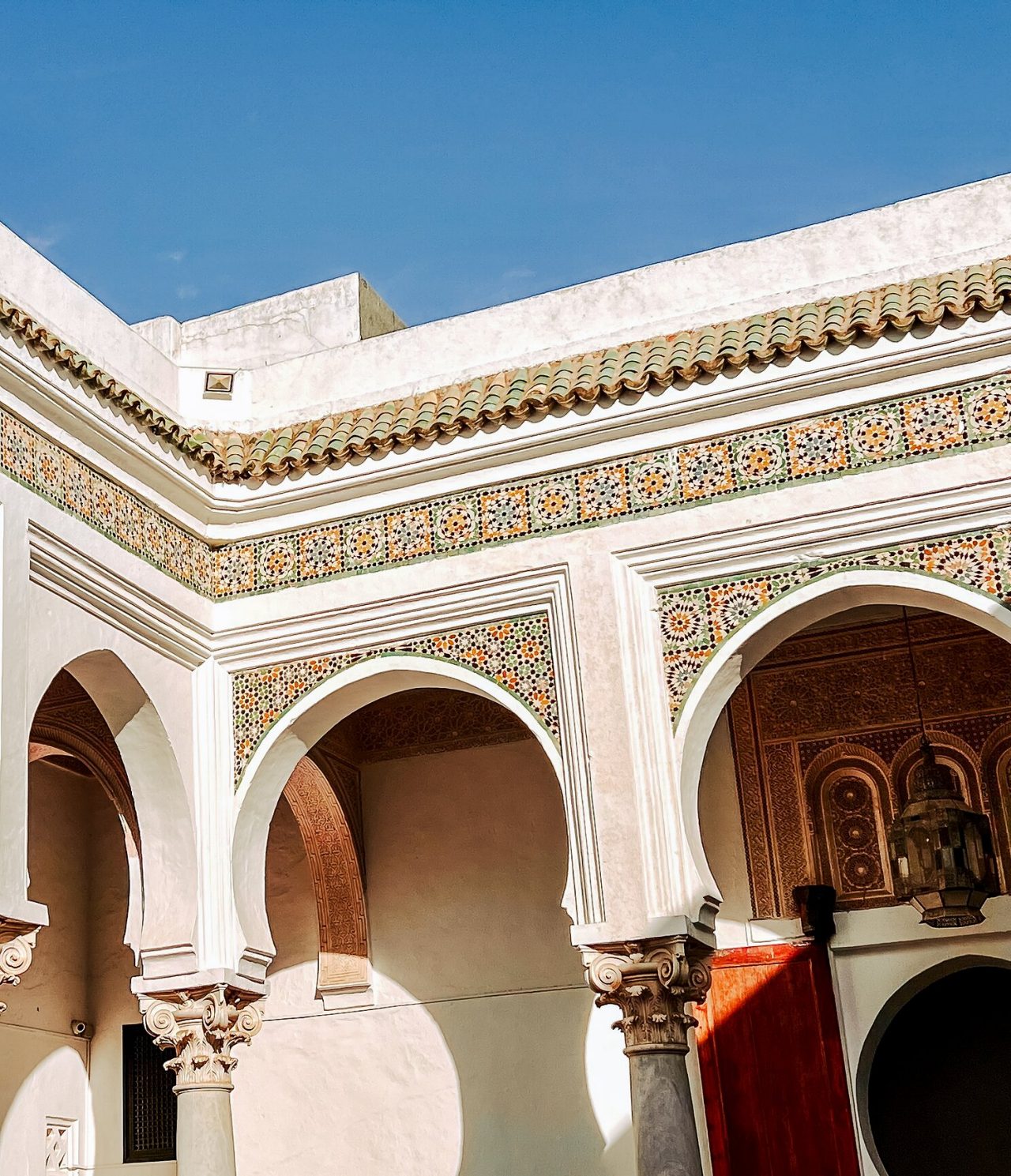 Descubra Hotéis em Tânger apresentando arcos mouriscos com mosaicos coloridos e pátio tradicional ao sol