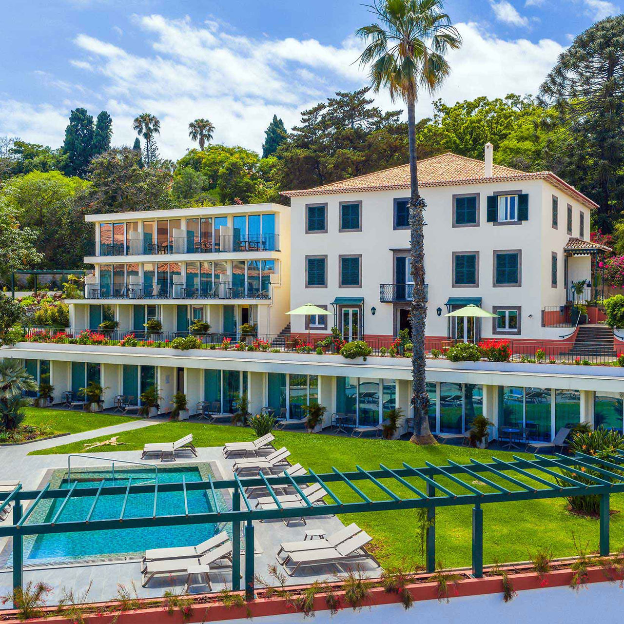 Hotel Pestana Quinta Perestrello, fachada com varandas e piscina rodeada por espreguiçadeiras e jardim verdejante